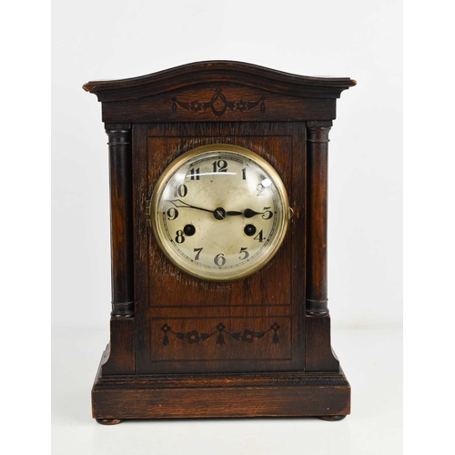 45 - A 1940s oak cased mantle clock, with Arabic dial, 34cms tall