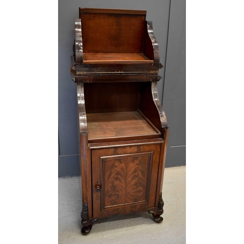 482 - A 19th century mahogany music cabinet, the top section lifting up above a panelled flame mahogany ve... 