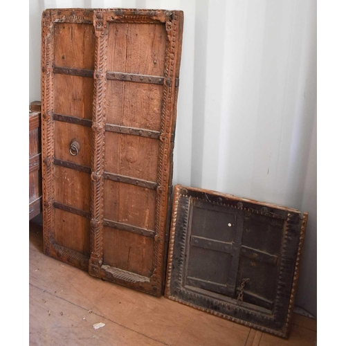 495 - A wooden carved pair of window shutters, together with a wooden window and frame.