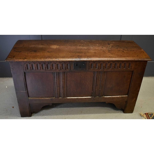 501 - An 18th century oak coffer, with nulled frieze above three panels, raised on stile and bracket feet,... 