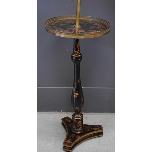 502 - An antique black lacquered and brass chinoiserie reading lamp, the height adjustable arm above a cir... 