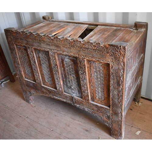 505 - A 19th century carved chest, the planked top above a four panel front, carved with decoration and ra... 