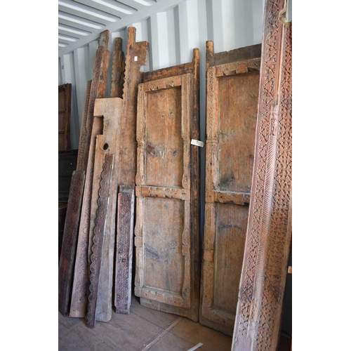 511 - A large door and frame, the two panel door, together with sections of carved panels to form a frame.