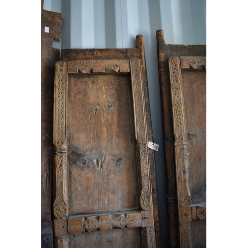 511 - A large door and frame, the two panel door, together with sections of carved panels to form a frame.