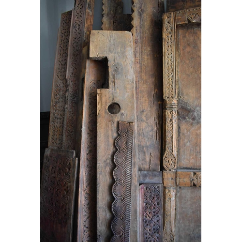 511 - A large door and frame, the two panel door, together with sections of carved panels to form a frame.