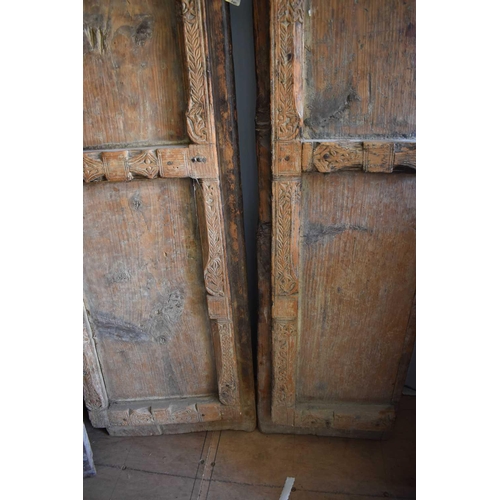 511 - A large door and frame, the two panel door, together with sections of carved panels to form a frame.