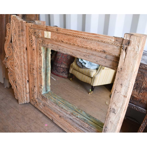 512 - A large wooden window frame, made into a mirror, with a twin scroll pediment, 116cms tall by 110cms ... 