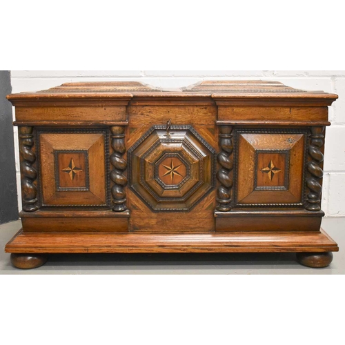 513 - A Dutch oak coffer, circa 1840, the break front centred by a relief moulded octagonal panel inlaid w... 