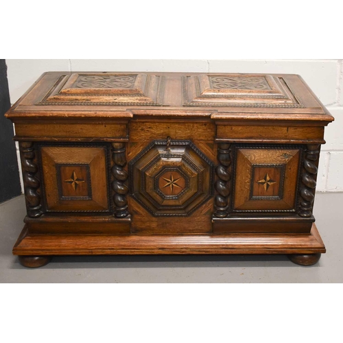 513 - A Dutch oak coffer, circa 1840, the break front centred by a relief moulded octagonal panel inlaid w... 