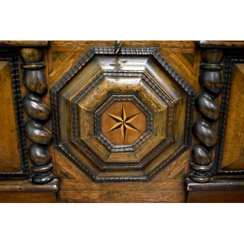 513 - A Dutch oak coffer, circa 1840, the break front centred by a relief moulded octagonal panel inlaid w... 