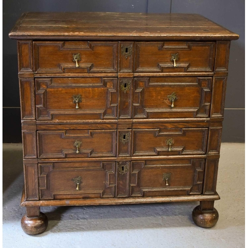 514 - An 18th century oak geometric moulded splitter chest, with four long drawers with brass drop handles... 