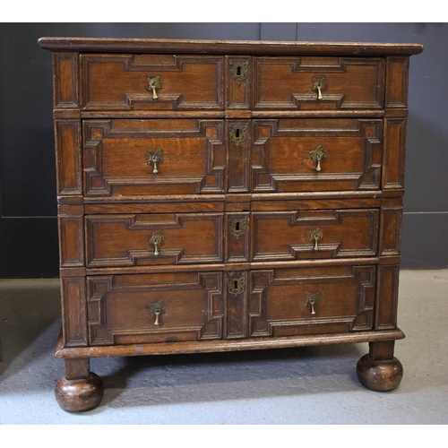 514 - An 18th century oak geometric moulded splitter chest, with four long drawers with brass drop handles... 