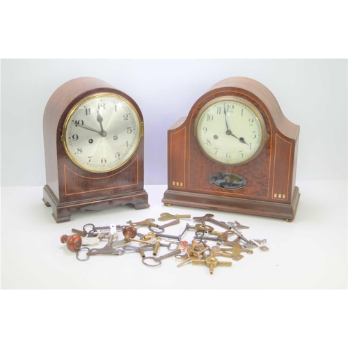 53 - Two mahogany cased mantel clocks with a quantity of clock keys.