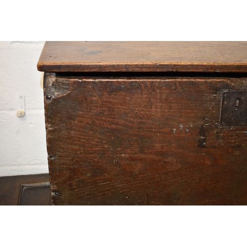 494 - A 17th century boarded oak coffer, with V cut end boards, chip carved corners, candlebox interior, a... 