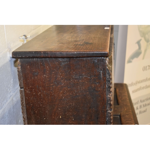 494 - A 17th century boarded oak coffer, with V cut end boards, chip carved corners, candlebox interior, a... 