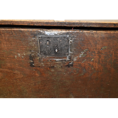 494 - A 17th century boarded oak coffer, with V cut end boards, chip carved corners, candlebox interior, a... 