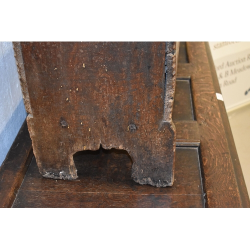 494 - A 17th century boarded oak coffer, with V cut end boards, chip carved corners, candlebox interior, a... 