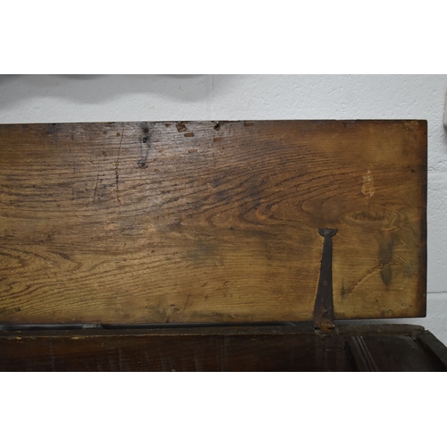 494 - A 17th century boarded oak coffer, with V cut end boards, chip carved corners, candlebox interior, a... 