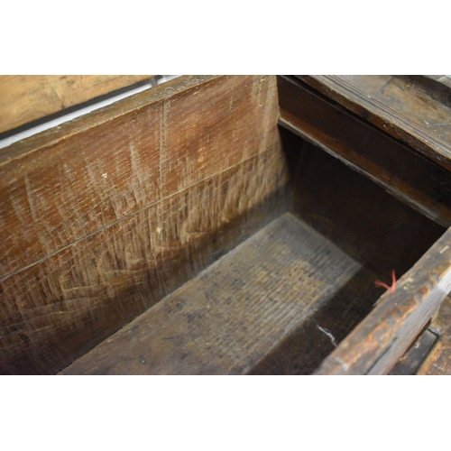 494 - A 17th century boarded oak coffer, with V cut end boards, chip carved corners, candlebox interior, a... 