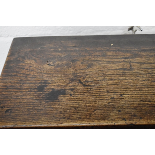 494 - A 17th century boarded oak coffer, with V cut end boards, chip carved corners, candlebox interior, a... 