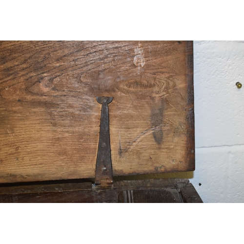 494 - A 17th century boarded oak coffer, with V cut end boards, chip carved corners, candlebox interior, a... 