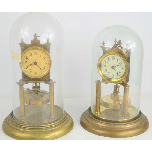 100 - Two German torsion pendulum clocks, both with glass domes,