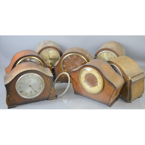 103 - A group of seven oak and mahogany mantle clocks to include examples by Bentima and Smiths, a/f.