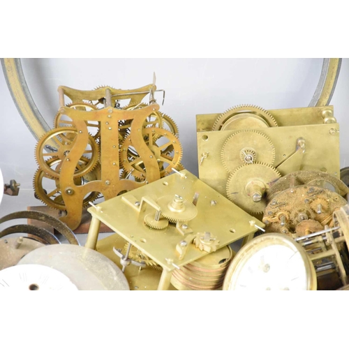 107 - A large group of clock parts to include dials, fusee movement, chapter ring, spring and other items.