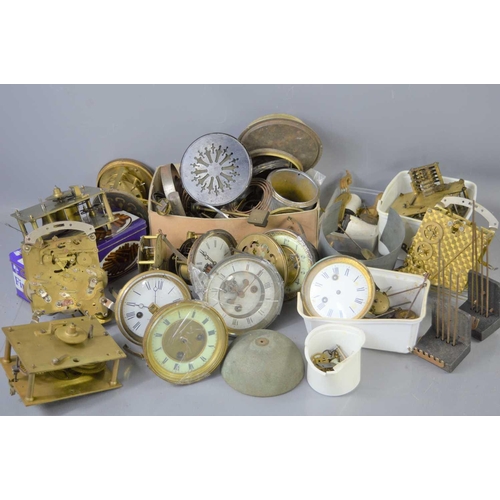 120 - A quantity of clock movements, dials and spares to include springs, chimes, wheels and other items.