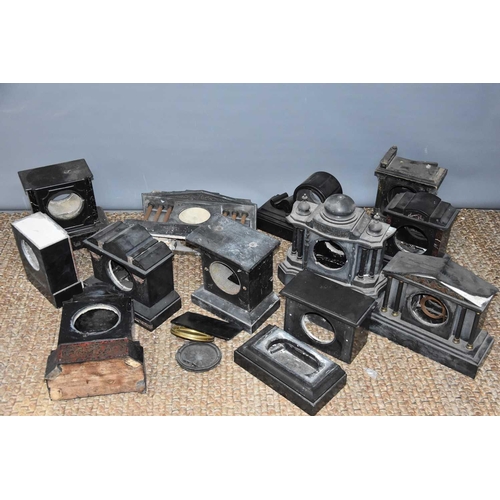 121 - A large group of slate clock cases of various different styles.