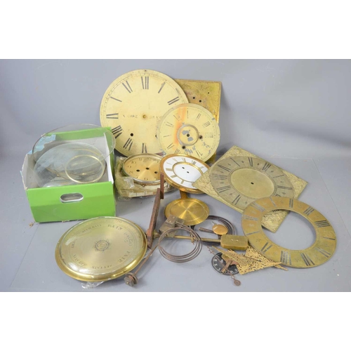 129 - A group of clock spares to include an 18th century brass clock face signed WM Tonnly, a brass chapte... 