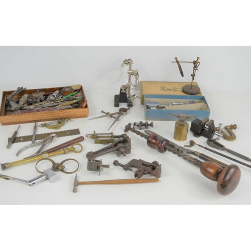 131 - A group of clock repair / making tools to include a small precision lathe, pliers, miniature anvil, ... 