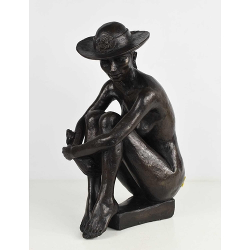 139 - A bronze style sculpture, nude woman wearing a hat.