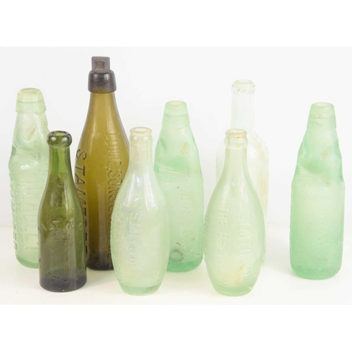 161 - Local Interest: A group of glass bottles to include Stamford and Oundle examples.