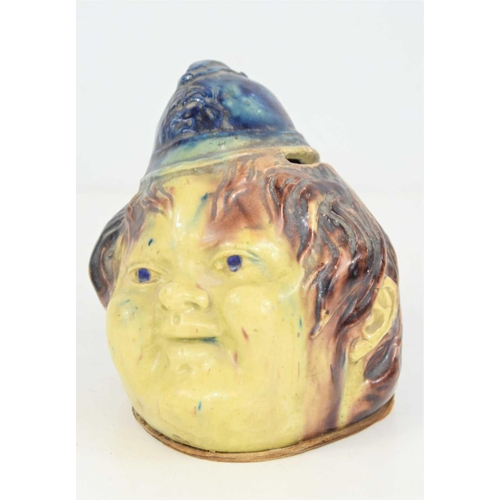 162 - A Victorian lead glazed money box in form of a smiling policeman, 12cm high.