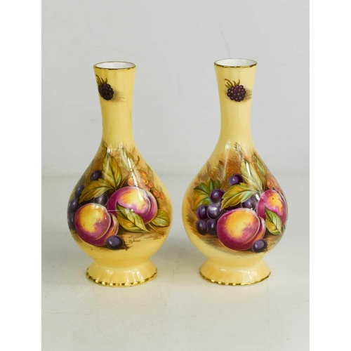 164 - A pair of Aynsley vases, painted with fruit on a cream ground.