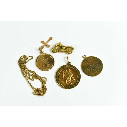 166 - A group of 9ct gold, to include three Saint Christopher pendants, a motorbike charm A/F, and a fine ... 