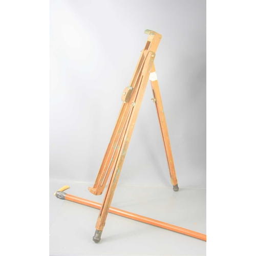 185 - A pine floor standing artist's easel together with two antique walking canes.