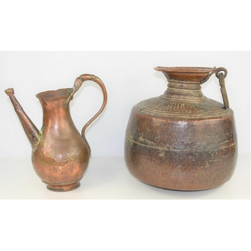 198 - A 19th century Indian Mughal hammered copper water storage pot, 31cm high together with a copper jug... 