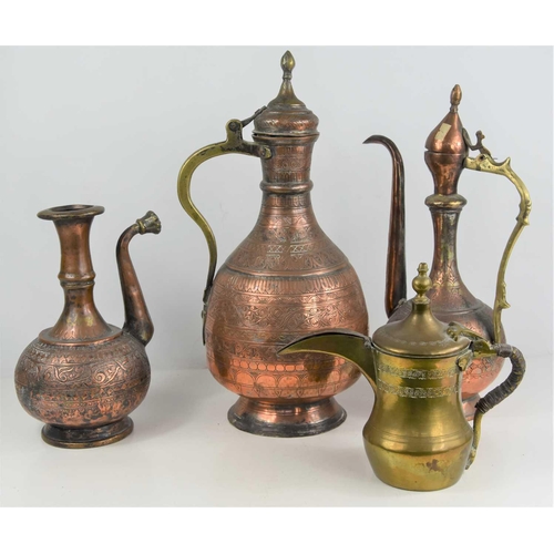 200 - A group of 19th century and later Middle Eastern copper and brass ewers together with a water storag... 