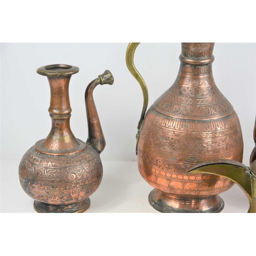 200 - A group of 19th century and later Middle Eastern copper and brass ewers together with a water storag... 