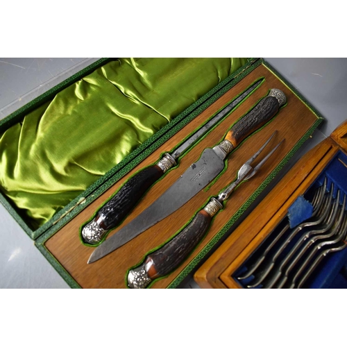 217 - An oak cased canteen of cutlery together with a vintage carving set in the original presentation box... 