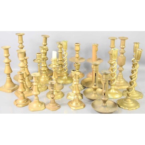 221 - A large group of 19th century brass candlesticks of various styles.