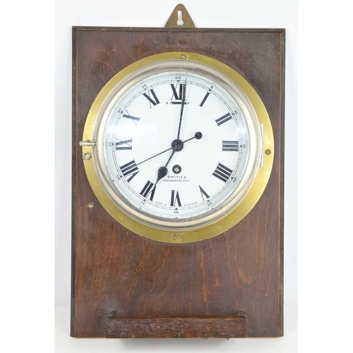 25 - A 20th century Smiths brass cased bulkhead clock with a single train eight-day movement, 19cms diame... 