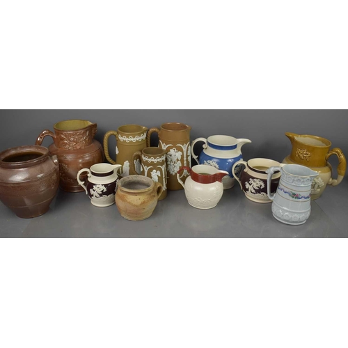 277 - A large group of antique jugs, to include Victorian examples, one modelled with Royal Crest, Jasperw... 