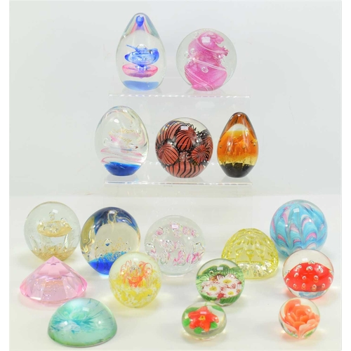 278 - A group of glass paperweights of various style and form.