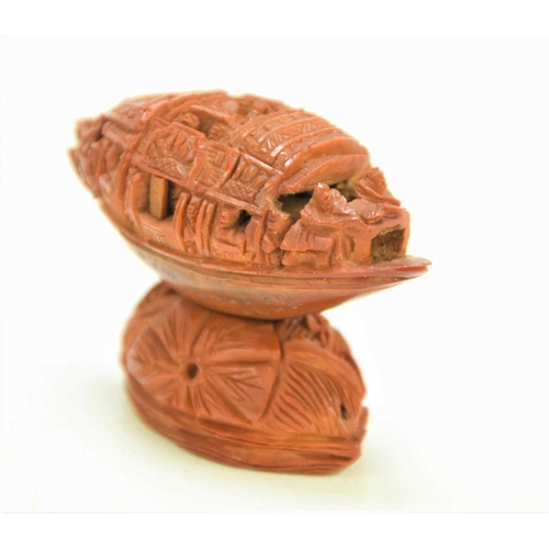 288 - A Chinese nut boat sculpture on stand, intricately carved with passengers looking out, the underside... 