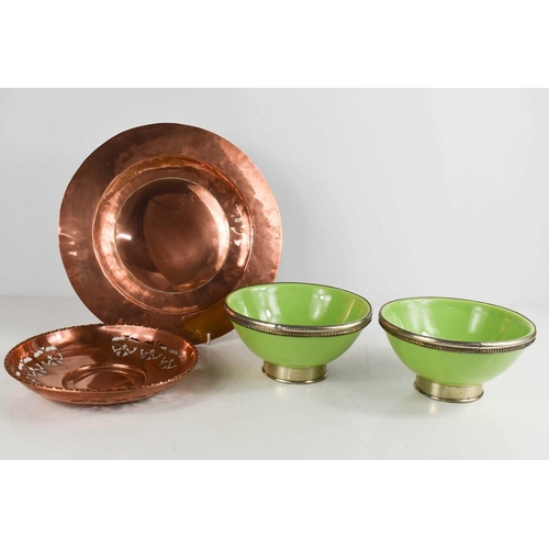 297 - An Art Nouveau copper pierced bowl and copper charger together with two green pottery bowls with whi... 