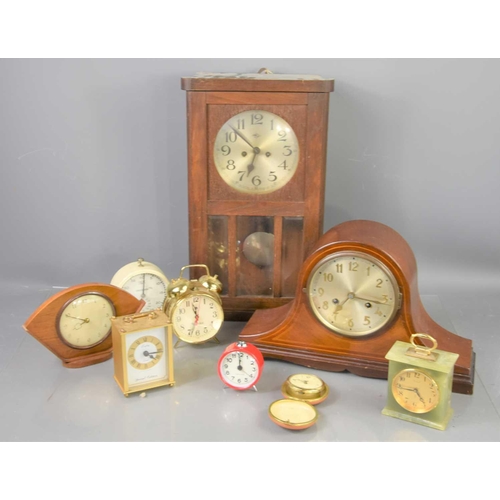 304 - A group of clocks to include an onyx mantle clock, Smiths alarm clock, oak cased wall clock. mahogan... 