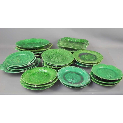 308 - A large group of Majolica green glazed leaf design plates, dishes and other items.